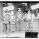 Children pose outside a restaurant hosting a Thanksgiving meal in 1910.